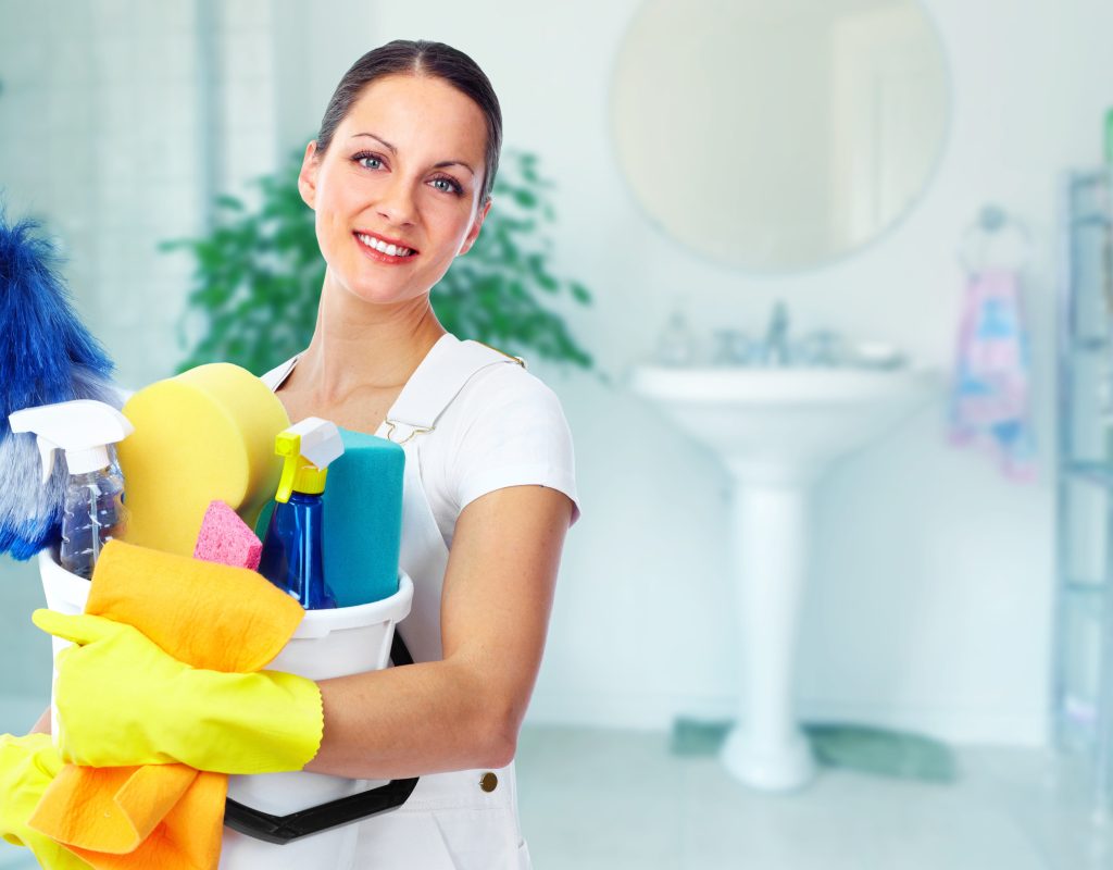 Young smiling maid. House cleaning service concept.